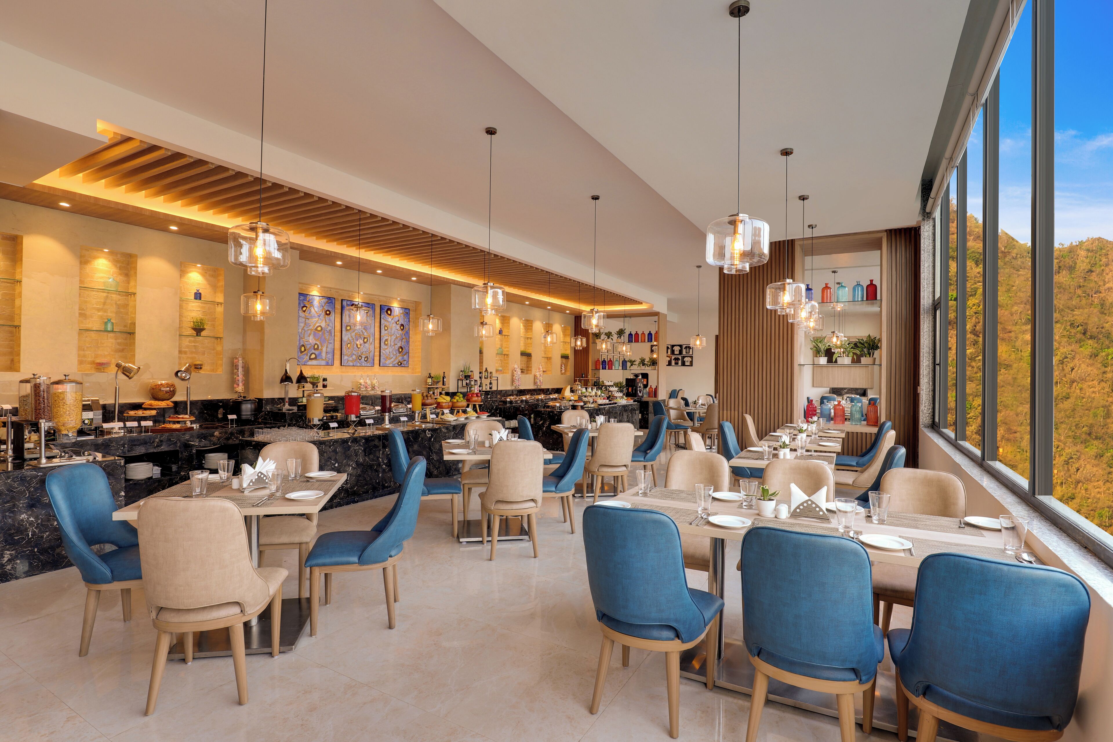A modern restaurant with a bar area, dining tables, and chairs.