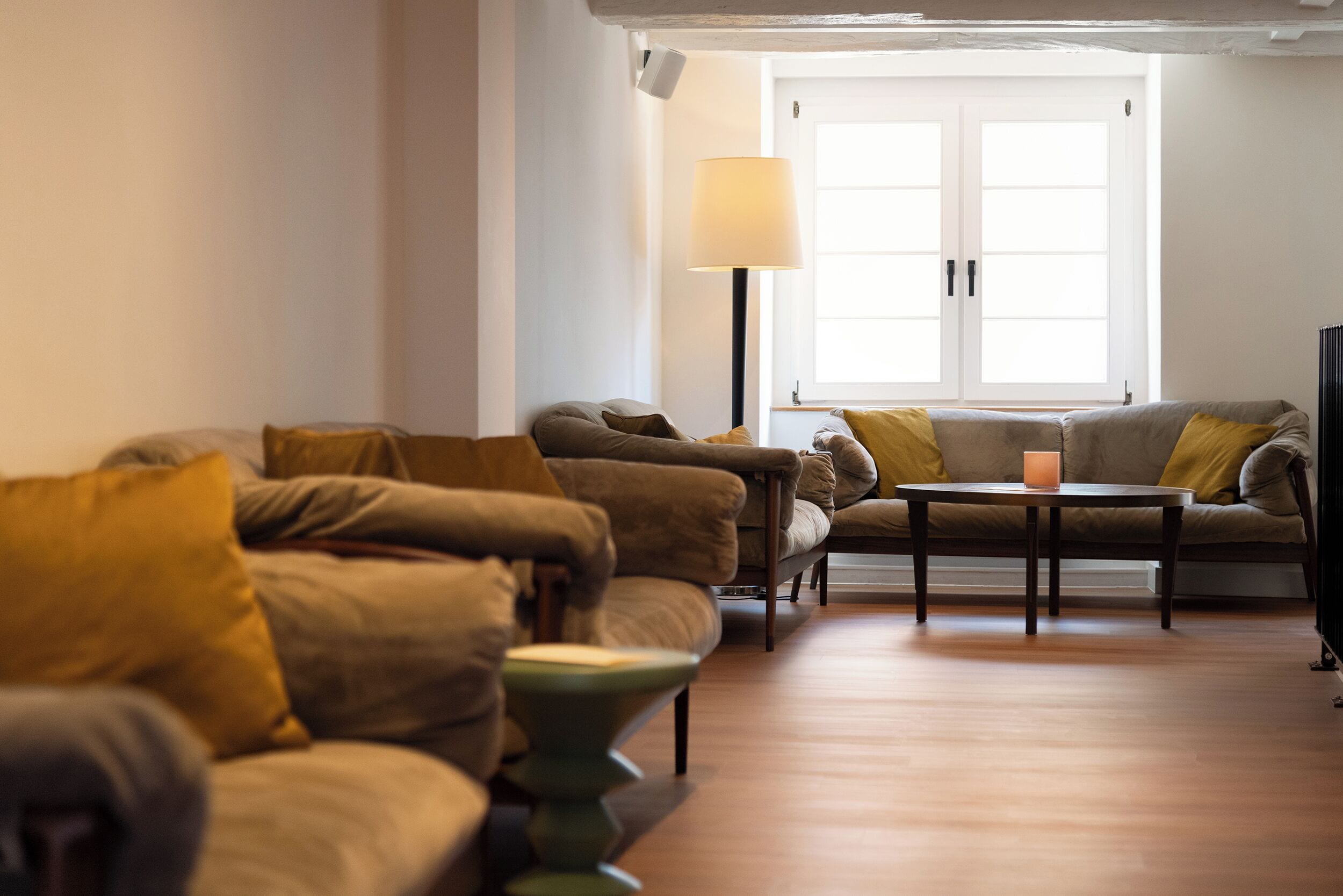 A living room with a sofa set, a coffee table, and a floor lamp.