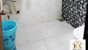 A bathroom with a sink, mirror, and shower. - K K Luxurious Home Stay (Garudeshwar)
