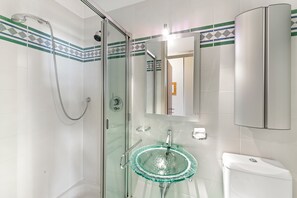 A modern bathroom with a glass-enclosed shower, a glass sink, and a white toilet. - Comfort Holiday In Paradiso With Lake Lugano View (Paradiso)