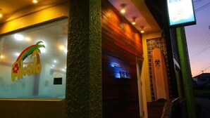 A restaurant with a 'Pension' sign, a 'Blue Wave' sign, and a wooden interior. - pension Aloalo (Shirahama)