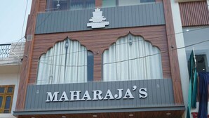 A building with a sign reading "Rooms" at the top and "MAHARAJA'S" below. - Maharaja Hotel and Restaurant (Ratia)
