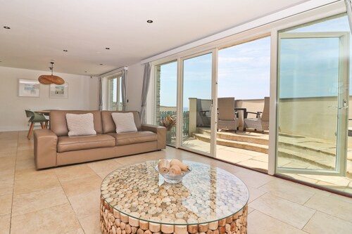 Beachside apartment with a private patio garden and beautiful sea views