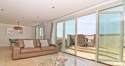Beachside apartment with a private patio garden and beautiful sea views