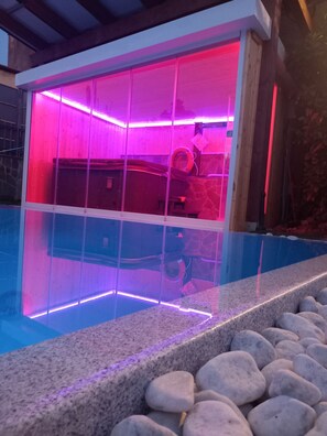 A swimming pool with a glass enclosure and a stone border. - VILLA IL MATTO with salt pool, with spa and sauna  (Toscana)