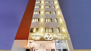 A hotel with a modern facade, multiple windows, and a prominent logo. - The Lavender Hotel (Bengaluru)