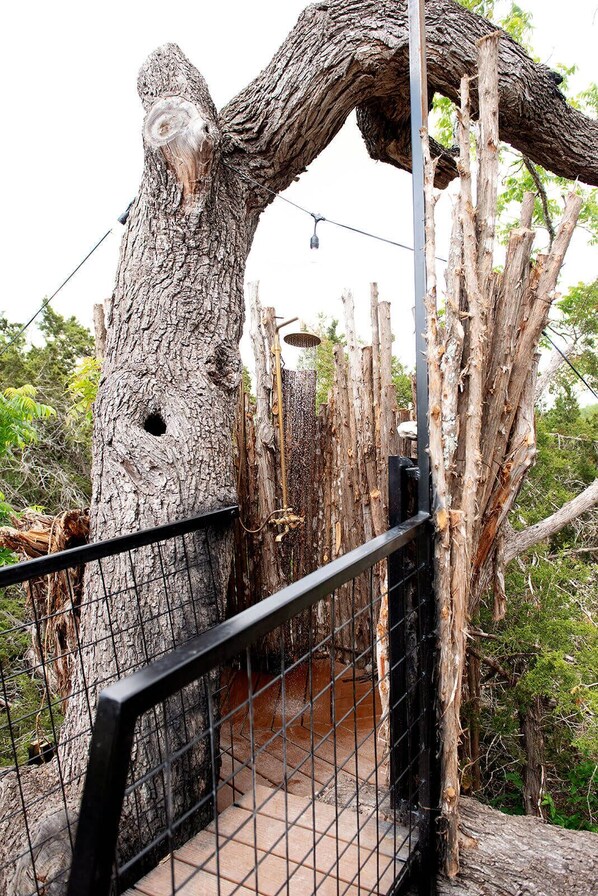 A treehouse with a metal railing and a wooden platform.
