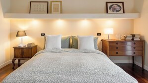 A neatly arranged bedroom with a large bed, two bedside tables, a nightstand, and a dresser. - A Casa Di Camillo, Nepi, a C (Nepi)