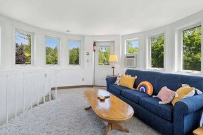 A room with a blue sofa, a wooden coffee table, and a radiator.