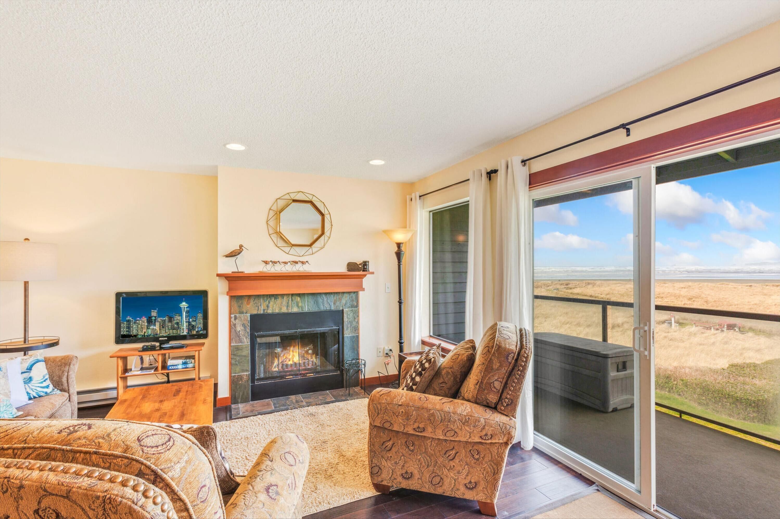 A living room with a fireplace, a television, and a sofa.