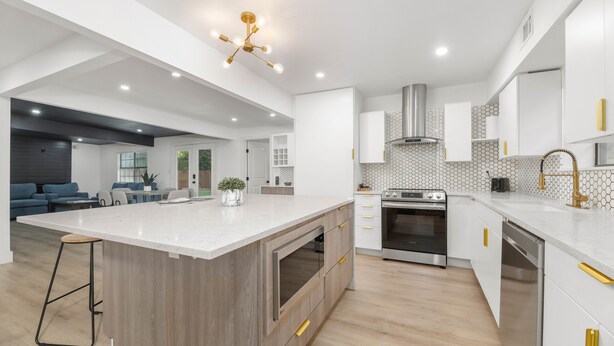 A modern kitchen with a large island, built-in oven, and stainless steel appliances. - Forest Hill Family Hideaway- 4-Bed Retreat (Dallas)