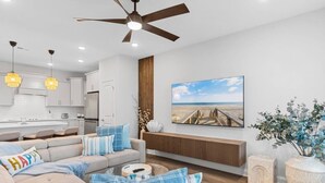 A modern living room with a sofa, a coffee table, and a painting of a beach scene. - Tee & Sea Paradise- Pool- Slps 11- Golf View-Grill (North Myrtle Beach)