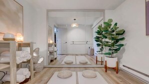 A modern bathroom with a wooden floor, white towels, a large mirror, and a potted plant. - Wilderness Ranch Retreat (Boise)