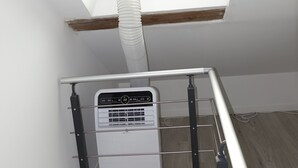 A room with a skylight, a white heater, and a metal railing. - Dijon : Superbe Appartement Hyper Centre en Duplex (Dijon)