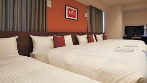 A hotel room with a large bed, a television, and a framed picture on the wall. - Y S Inn Naha Oroku Ekimae (Naha)