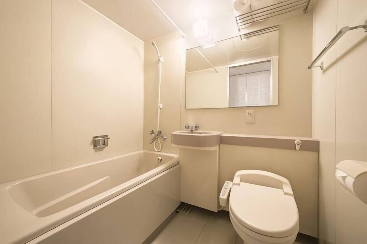 A bathroom with a bathtub, sink, and toilet.