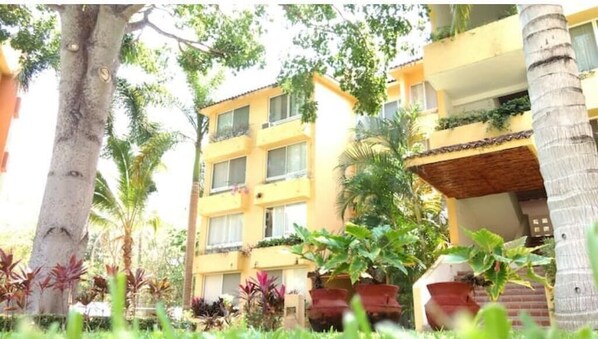 Stunning building with lush greenery and balconies.