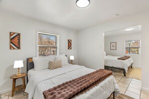 2 habitaciones, escritorio y tabla de planchar con plancha