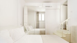 A modern hotel room with a large bed, a walk-in closet, and a staircase. - CDT Duomo - Three Bedroom Apartment, Sleeps 6 (Firenze)