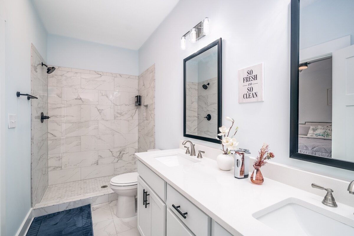 A modern bathroom with a shower, toilet, and vanity.
