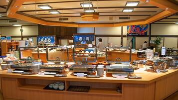 A buffet counter with various food items and a clock on the wall.