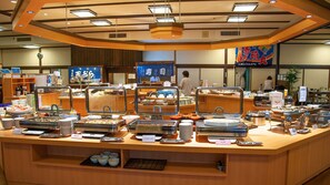A buffet counter with various food items and a clock on the wall. - Misasa Royal Hotel (Misasa)