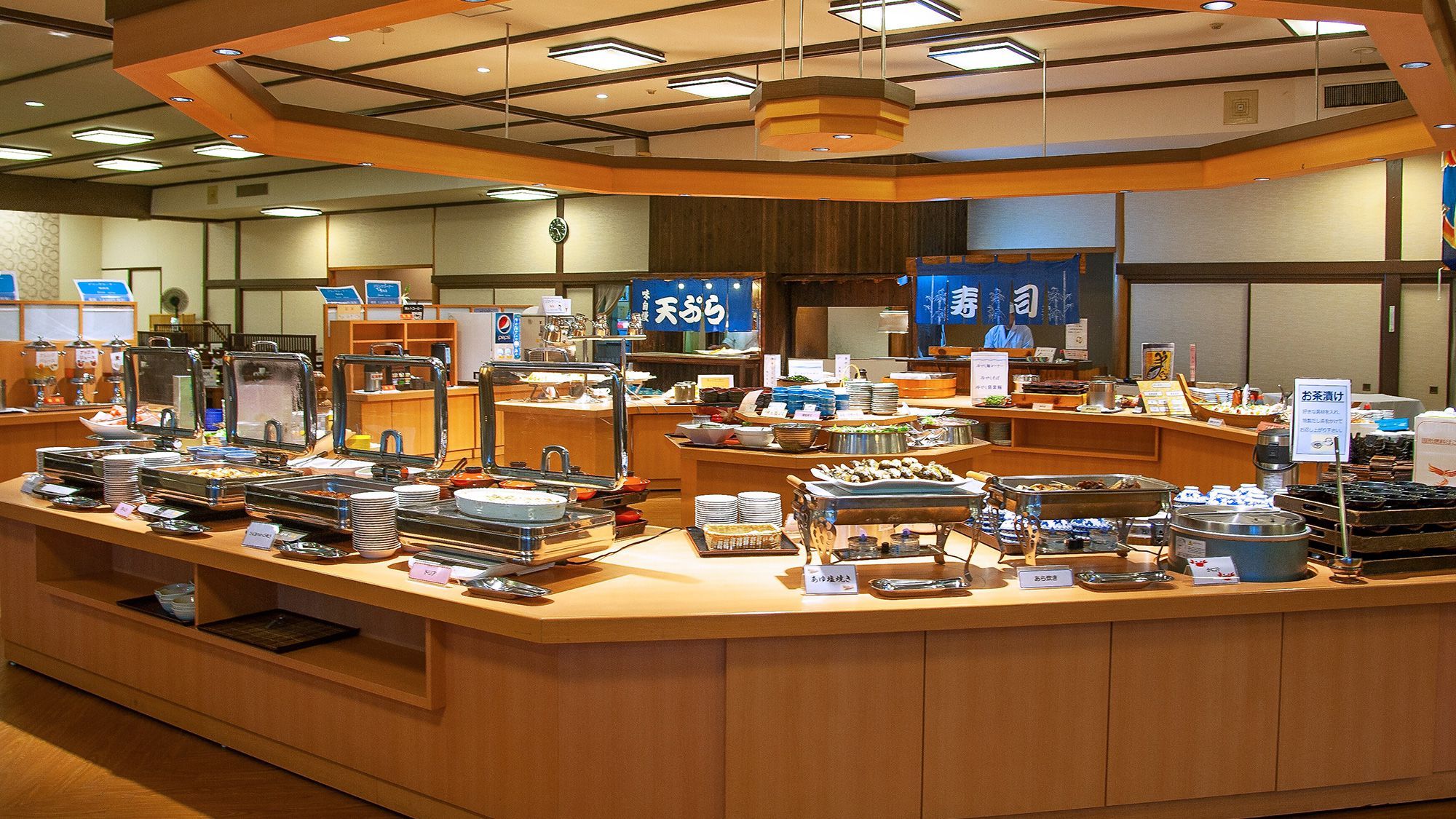 A buffet area with various food stations and a cashier counter.