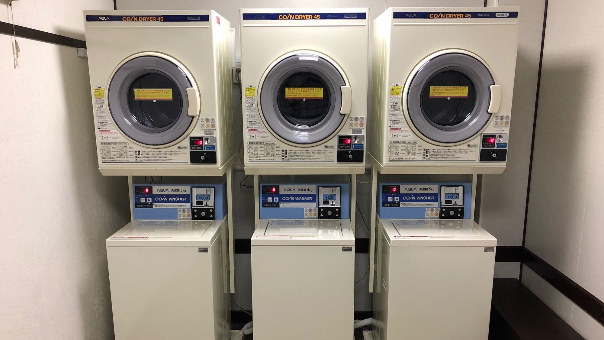 Three identical CO/N DRYER 45 machines with a 5kg capacity, each with a digital display and control panel.