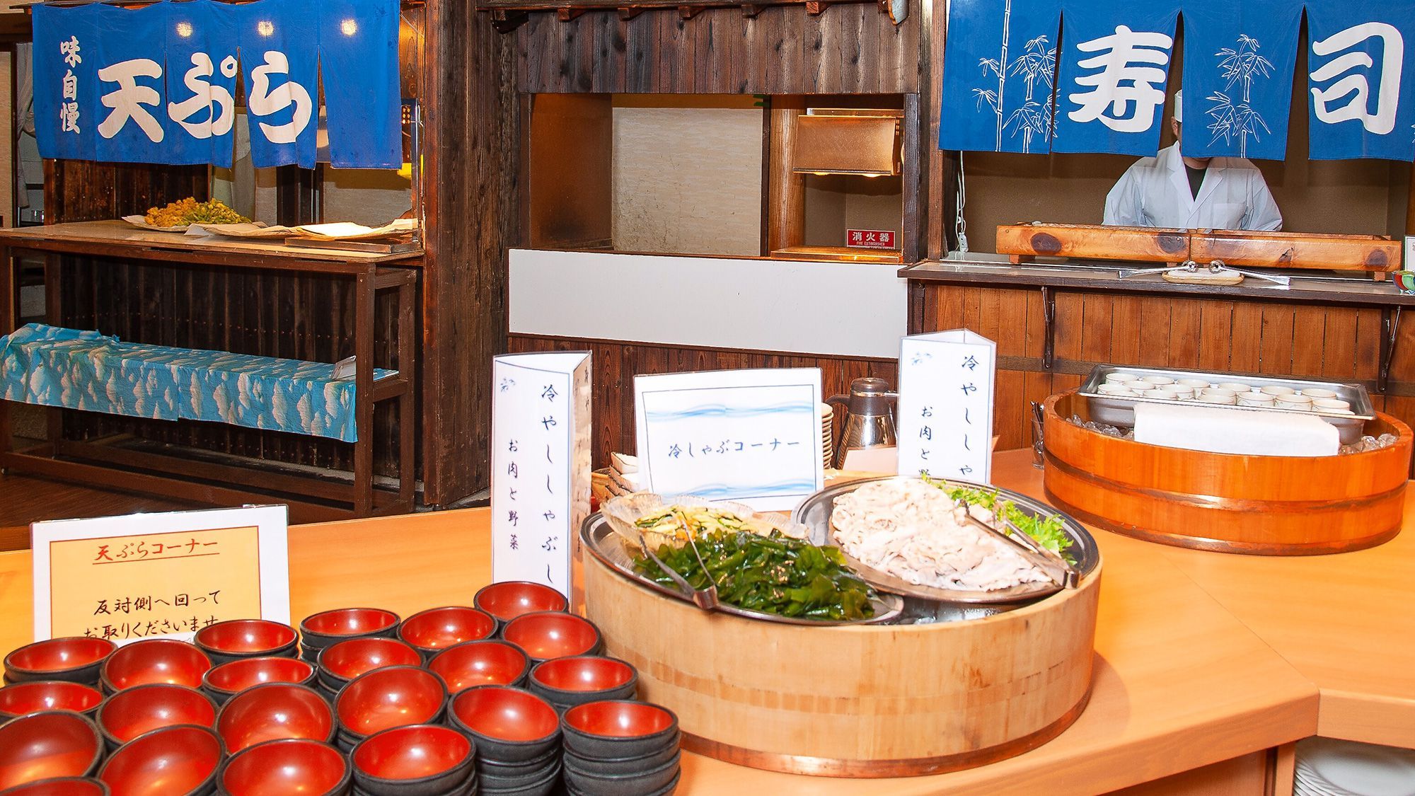 A buffet setup with various dishes and serving utensils.