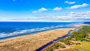 A coastal landscape with a river, beach, and forested area. - Captain Green s Cabin (Copalis Beach)