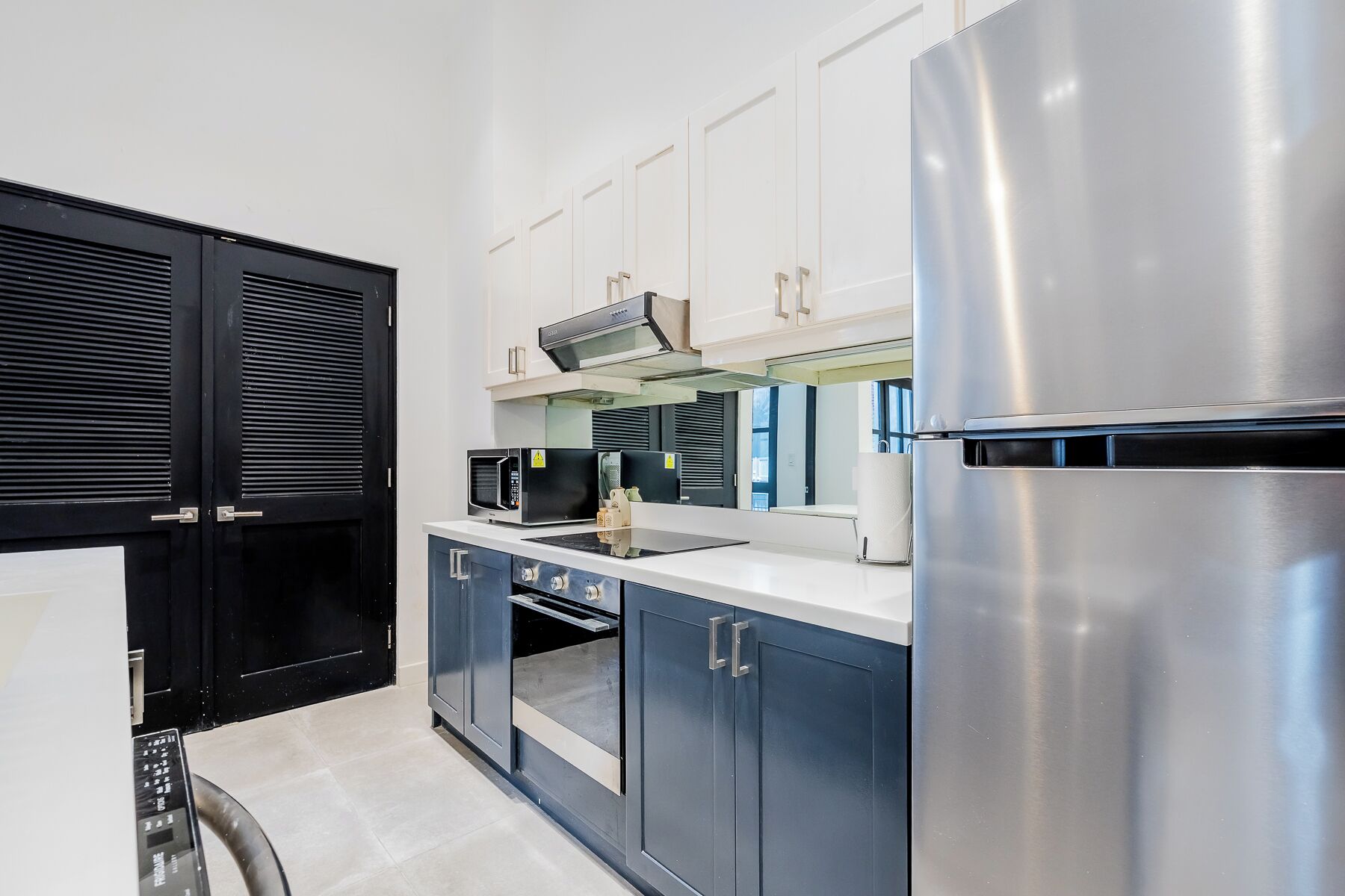 A modern kitchen with stainless steel appliances, a microwave, and a built-in oven.