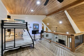 A loft bedroom with a bunk bed, a desk, and a computer. - Whitetail Run | Beautiful custom cabin 2BR + Loft sleeps 10 w/ hot tub (Broken Bow)
