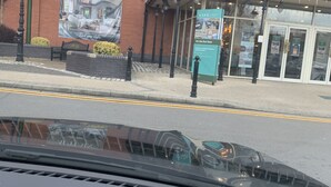 A building with a brick facade, a large banner advertising an autumn sale, and a sign for a cafe. - Ocean villa (Nassau)