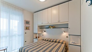 Ein Schlafzimmer mit einem Bett, einem Schreibtisch und einem Kleiderschrank.