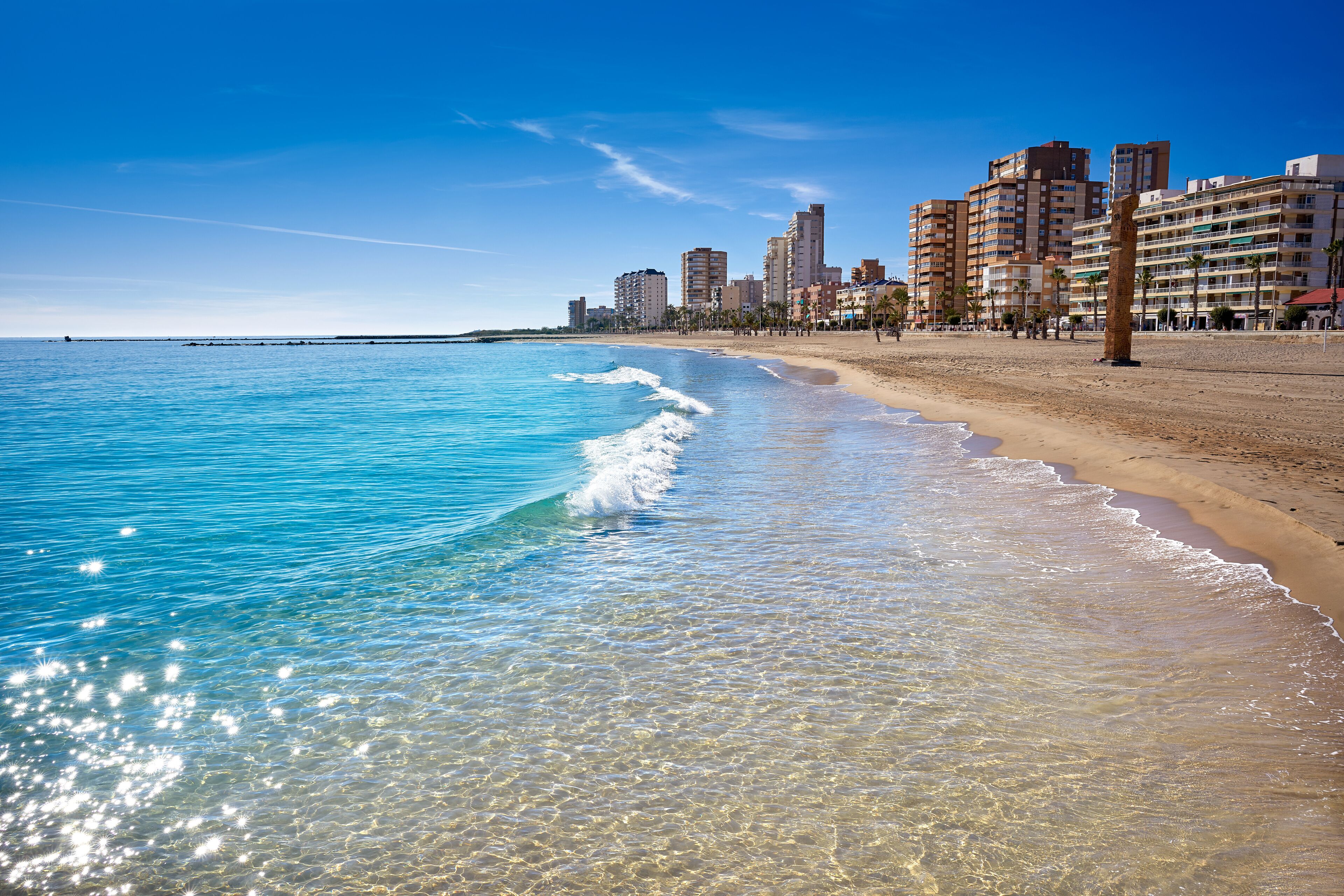 On the beach, white sand, beach umbrellas, beach towels