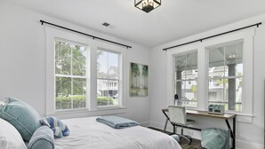 A bedroom with a bed, a desk, and large windows. - Park Circle's Blue Ranch                      -Charleston- (North Charleston)