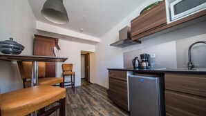 A compact kitchen with a microwave, coffee maker, and a small refrigerator. - GITE VAUBAN NEUF-BRISACH (NEUF BRISACH)