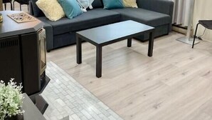 Un soggiorno moderno con un divano, un tavolino da caffè e un'area pranzo sullo sfondo.