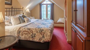 A bedroom with a large bed, a bedside table, a lamp, a window with curtains, and a wardrobe. - Spacious Private Suite with full kitchen, private deck and pet friendly! (Blowing Rock)