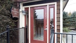 A red front door with the number 1222, a mailbox, and a sign indicating a suite. - Spacious Private Suite with full kitchen, private deck and pet friendly! (Blowing Rock)