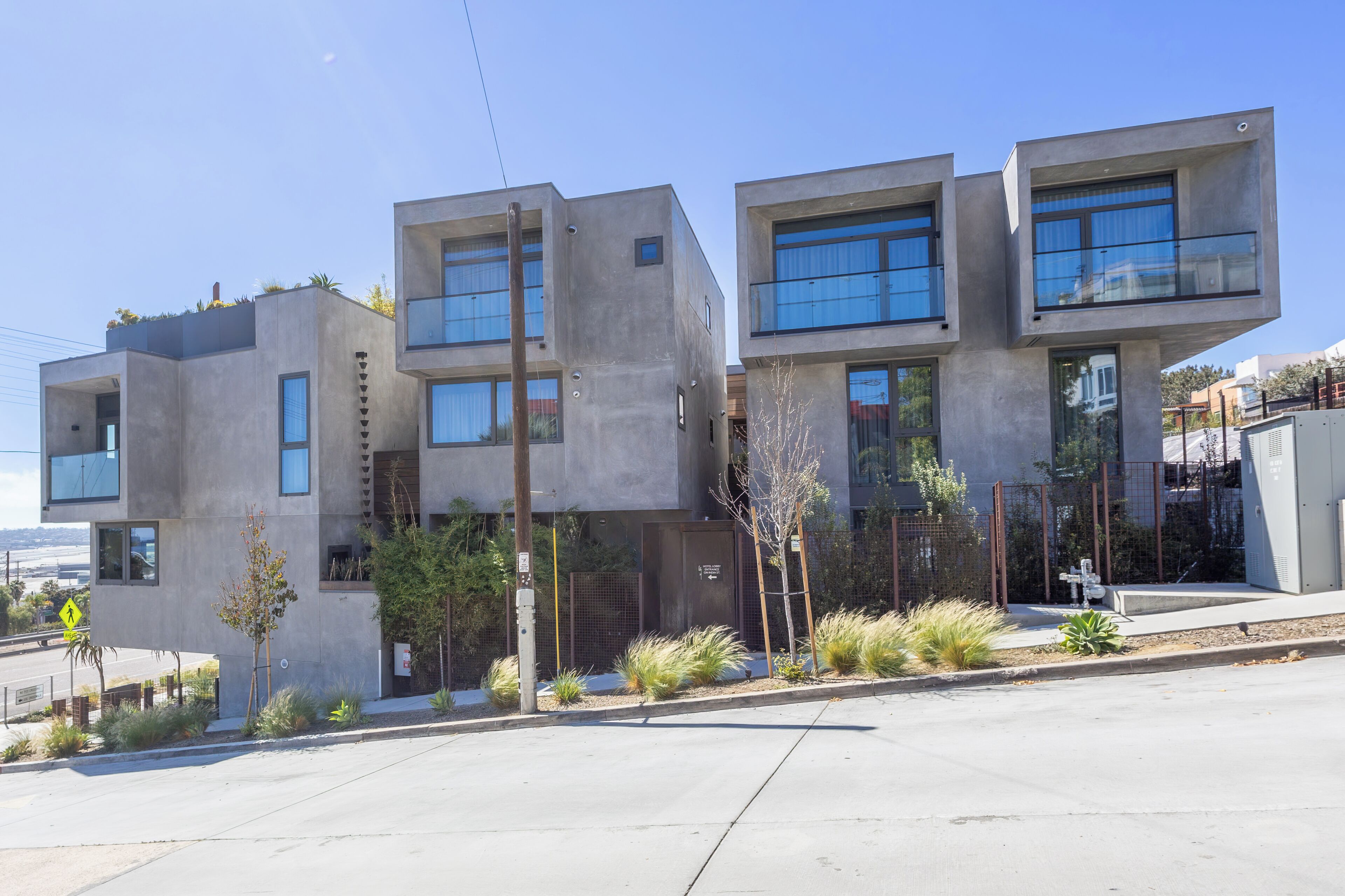 A modern building with a flat roof, large windows, and a concrete facade.