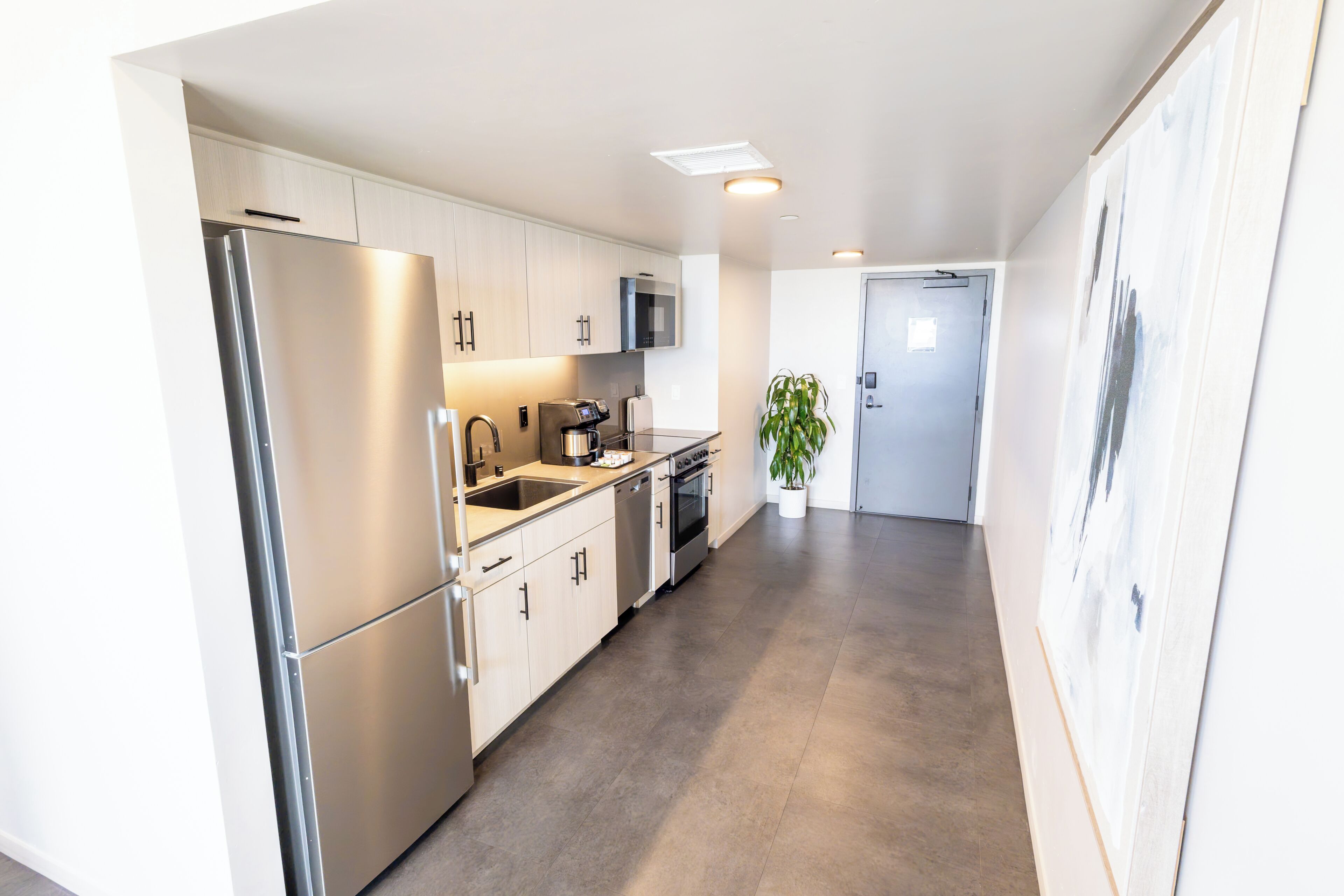 A modern kitchen with stainless steel appliances, a microwave, and a dishwasher.