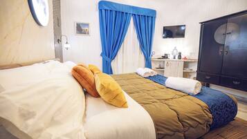 A hotel room with a bed, a nightstand, a TV, and a wardrobe.