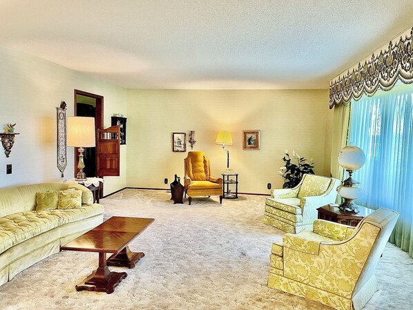 A living room with a sofa, armchair, and a coffee table.