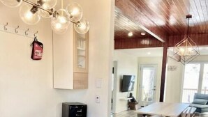 A modern kitchen with a wooden countertop, white cabinetry, and a pendant light fixture. - Lakeside Cottage Getaway South Shore Lake Scugog

 (Caesarea)