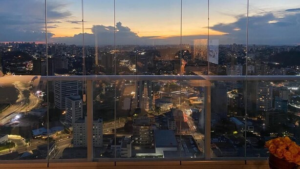 A cityscape view from a high-rise window with multiple floors and a clear sky.