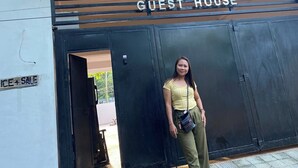 A building with a sign reading "MANEL GUEST HOUSE" and a balcony above the entrance. - We provide transport going to shopping center, restaurants and tourism office. (Donsol)