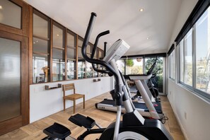 A home gym with treadmills, a stationary bike, and a rowing machine. - ZAMORA by Mr. W (Mexico City)