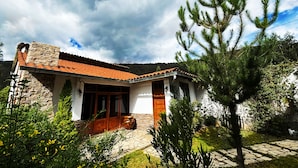A house with a stone facade, a tiled roof, and a wooden door.