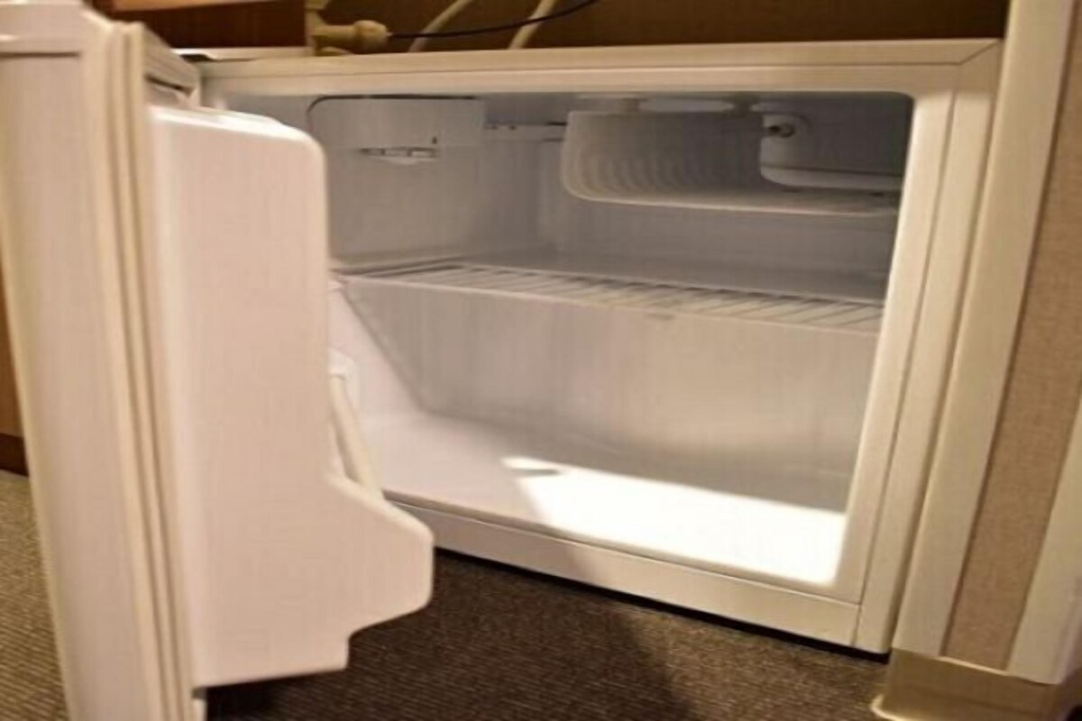An open refrigerator with a freezer compartment visible.